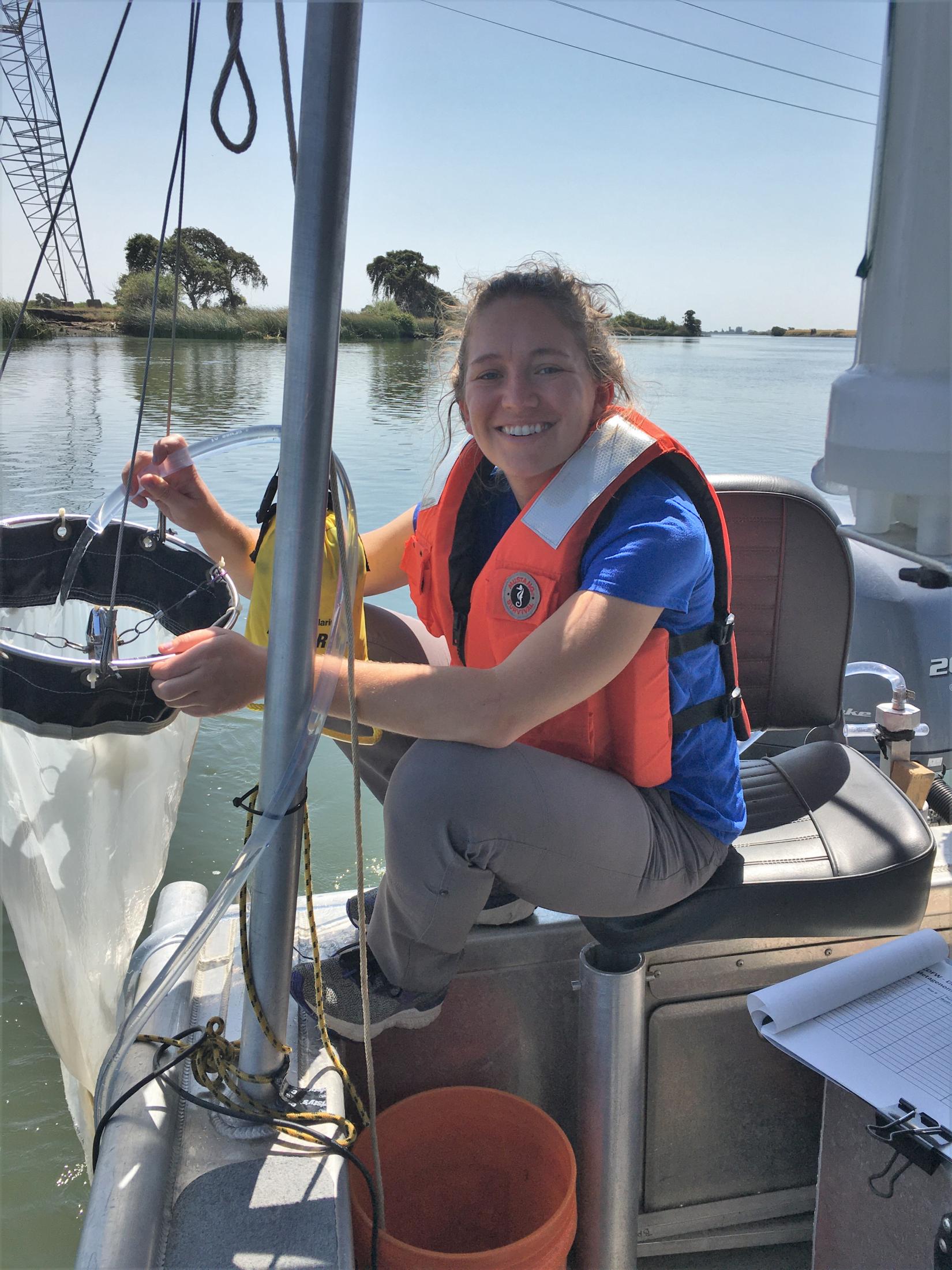 Amanda on a boat filtering water