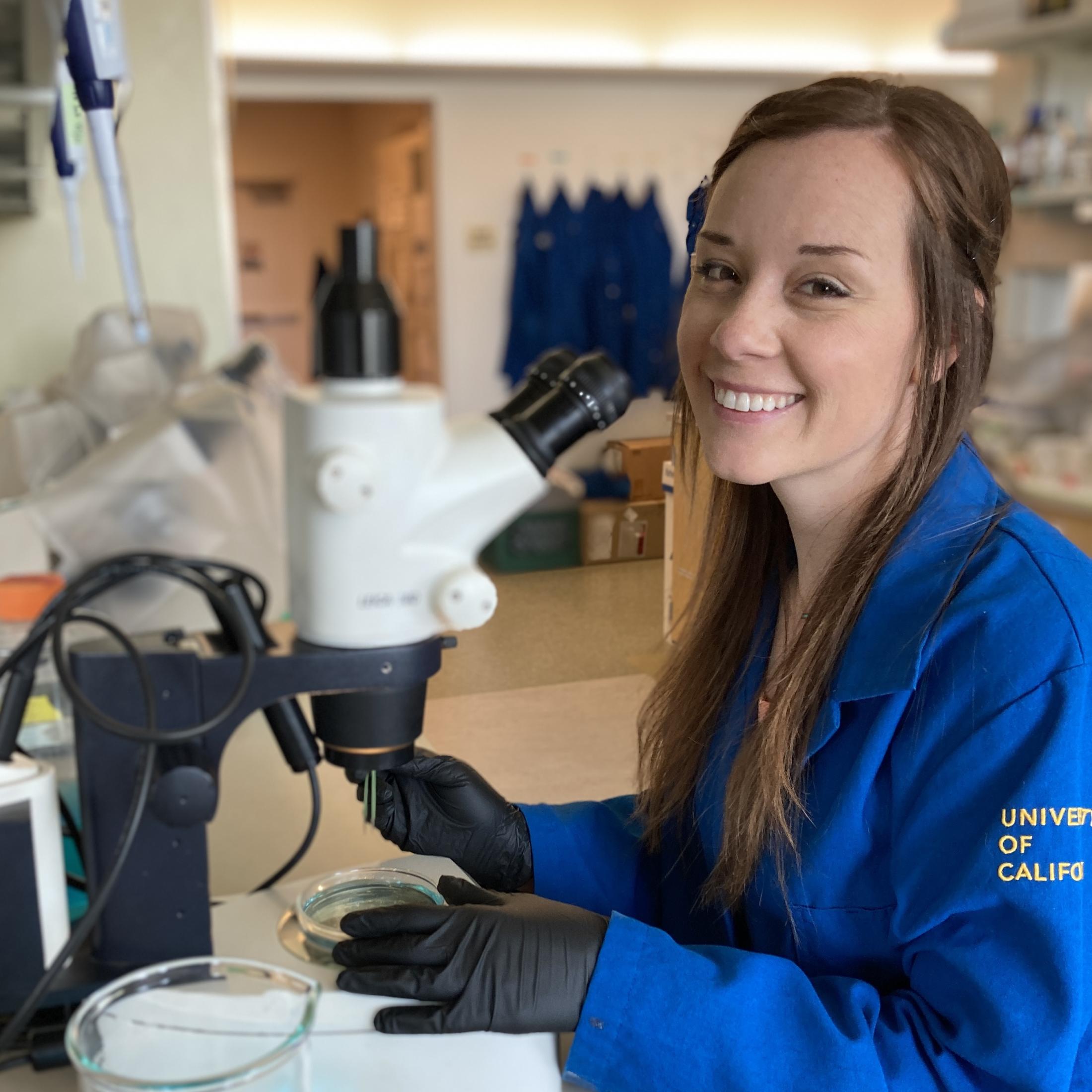 Jenn working with a microscope in the lab