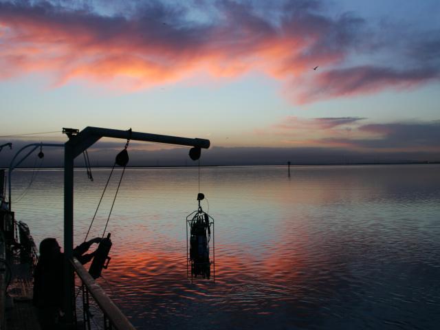 Water sampling rig in the San Francisco Bay as the sun sets