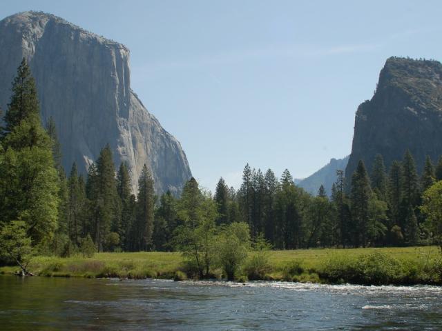 Yosemite valley including a body of water, trees, and El Capitan